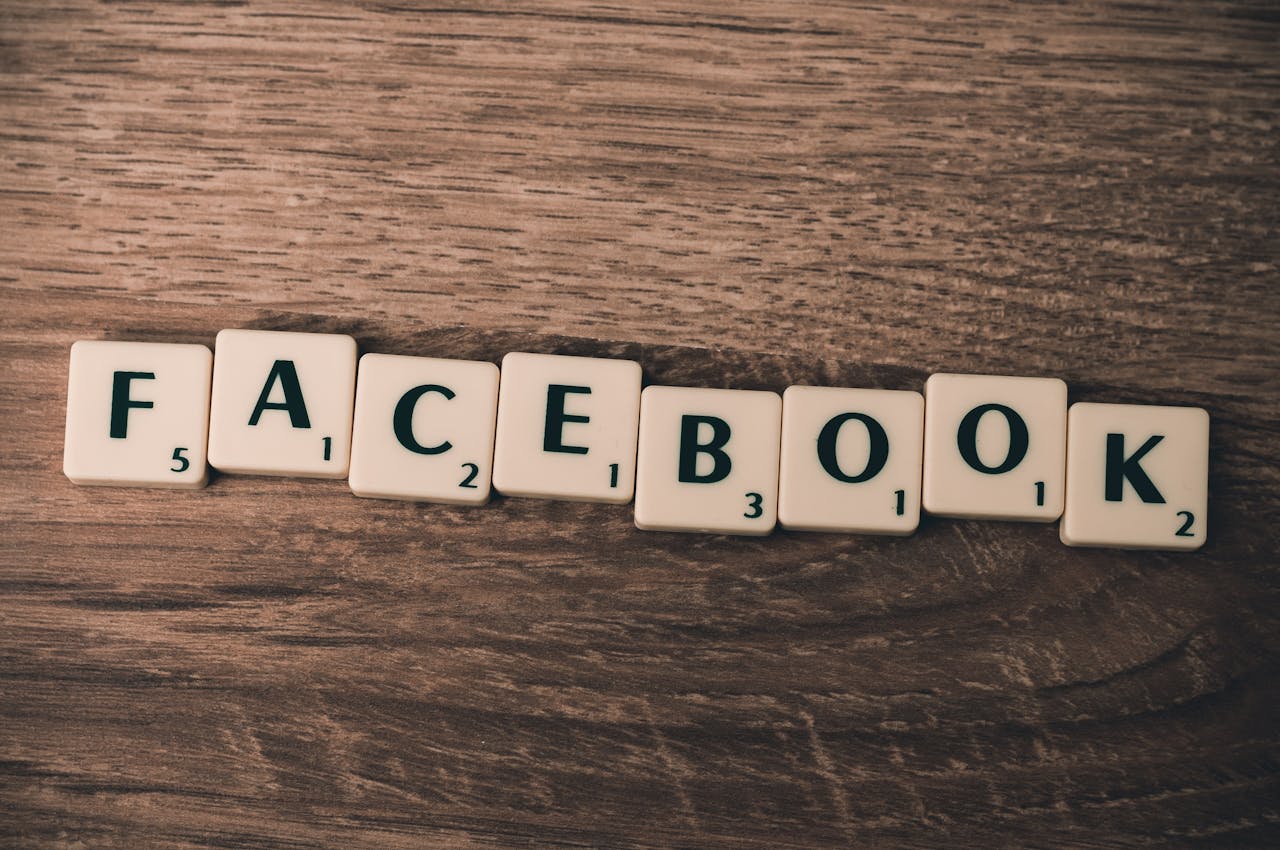 services-img Scrabble tiles spelling 'Facebook' on a wood background, symbolizing social media.